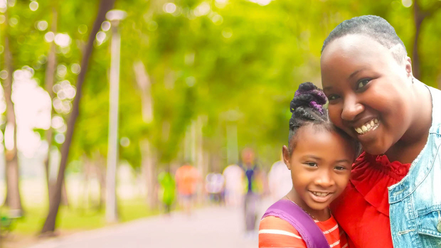 Jazmin Williams hugging her daughter, Kyra in a park
