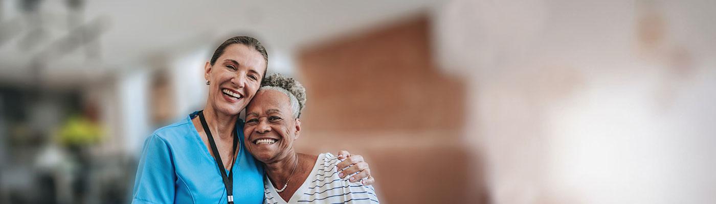 Nurse and patient hugging and smiling