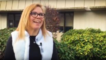 Julie Liles in a white vest, smiling