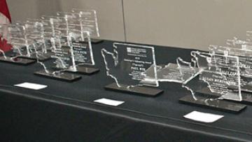 Draped table displaying Governor’s Lifesaving Award statues