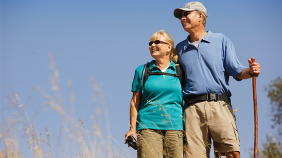 Older couple hiking and taking in the view