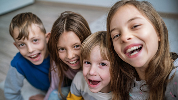 Four children laughing and playing