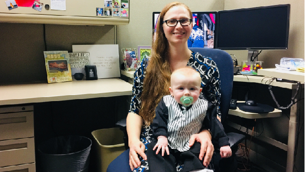 Stefanie and Finn Zier sitting at Stefanie's desk at HCA